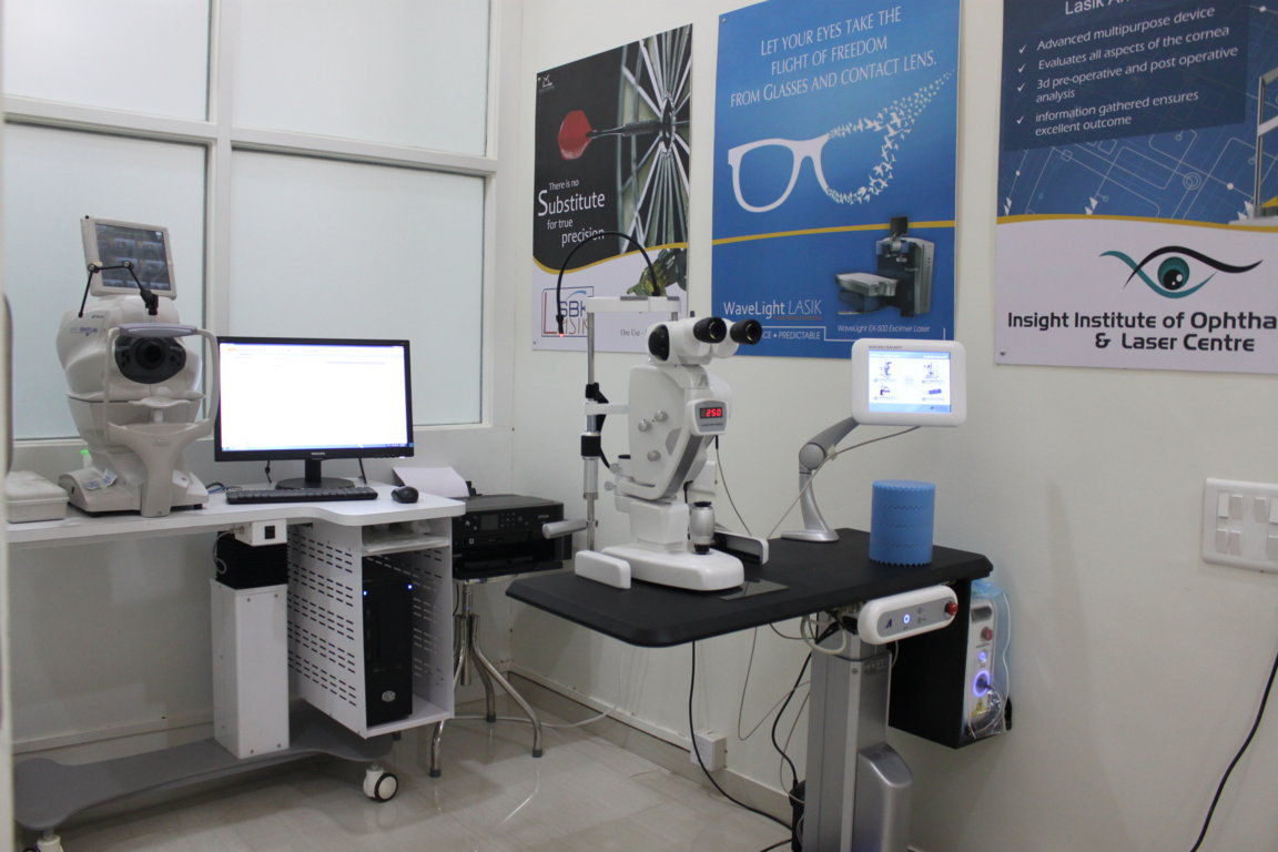 LASIK candidacy workup suite at Insight Institute combining a Lenstar optical biometer, a Humphrey-style visual field analyzer and a refraction slit-lamp